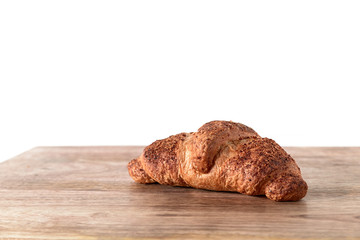 sweet croissant isolated on wooden table