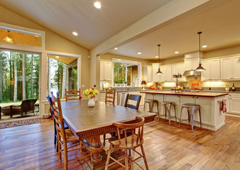 Well lit dinning room with connected living room.