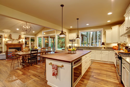 Classic Kitchen With Hardwood Floor And An Island.