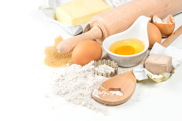 Flour, eggs, yeast, sugar, butter. Wooden kitchen utensils. Food