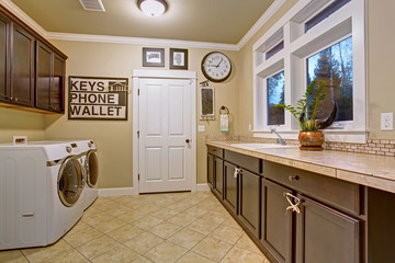 Nice laundry room with tile floor.
