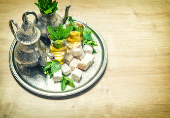 Mint tea with arabic delight. Oriental hospitality. Vintage styl
