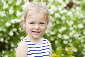 Close up portrait of a six year little girl, against background