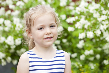 Close up portrait of a six year little girl, against background