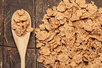 Corn flakes over old wooden table