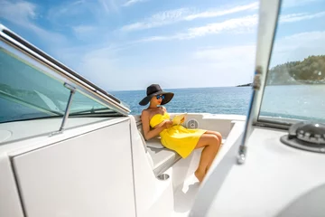 Papier Peint photo Naviguer Woman relaxing with digital tablet on the yacht