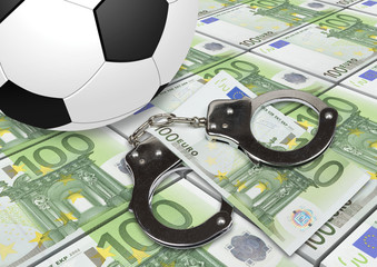 Soccer gambling corruption concept. Soccer ball with money and handcuffs.