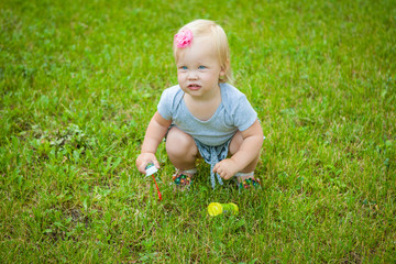 Little girl on nature playing toy