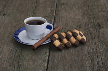 coffee of a circle and a row of contrasting cookies