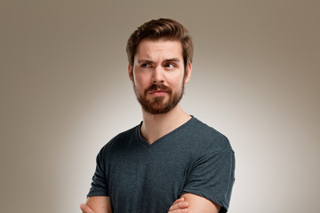 Portrait of young man with beard, think about
