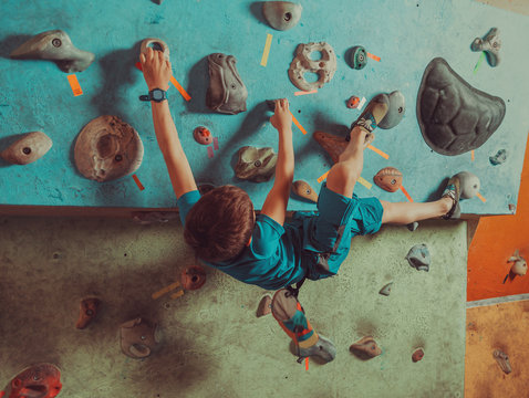 Boy training in climbing gym