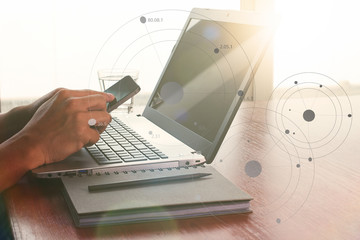 Close up of business man hand working on laptop computer on wood