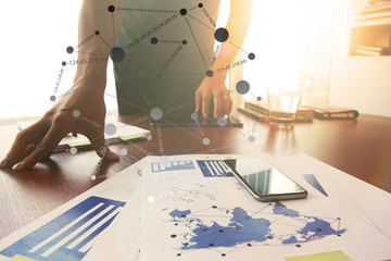 Young creative designer man working at office and social network