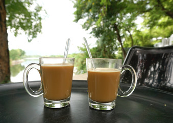 two hot coffee glasses on table
