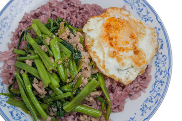 Stir-fried morning glory with pork and eggs on rice, Thai food.