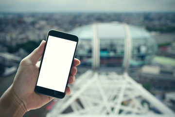 man hand holding blank screen smartphone against london city blu - obrazy, fototapety, plakaty