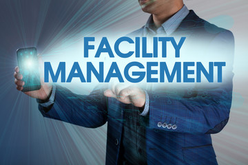 Businessman presses button facility management on virtual screen