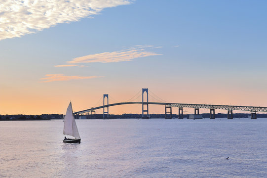 Newport Bridge twilight sunset with sailboats Rhode Island USA a popular New England holiday vacation destination. 