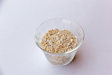 Oats in a crystal cup on a white background