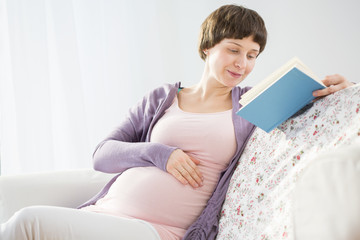 Pregnant woman reading a book