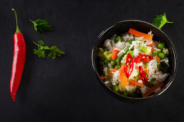 White Rice and  vegetables on a black board.
