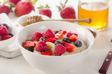 Oatmeal porridge with fresh Berries for  a Healthy Breakfast.