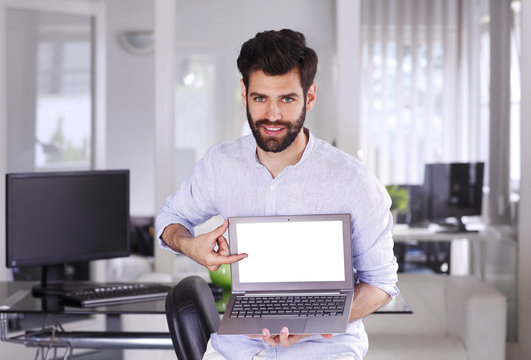 Young professional holding laptop