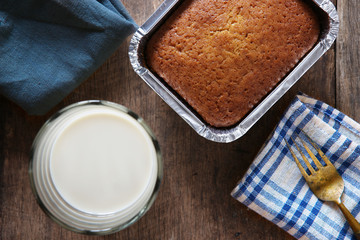 Banana Bread with Rich Milk as Breakfast on Wooden Background.