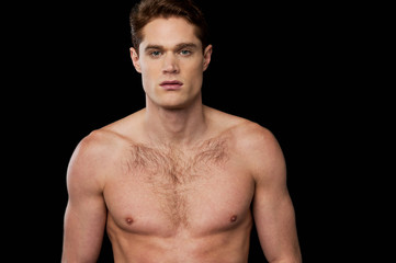 Fototapeta premium Muscular man posing over black