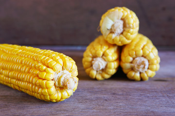 Corns on Wooden Background.