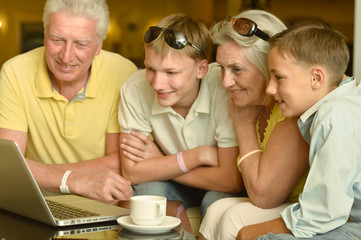 Boys with grandparents  and laptop