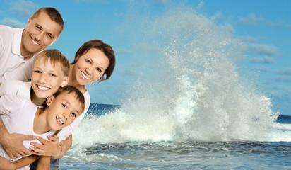 friendly family on a background of sea wave