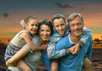 Friendly family on a background of a sunset