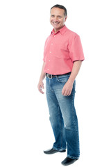 Casual aged man standing over white