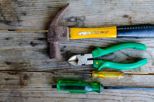 old many kinds of tools is placed on a wooden table