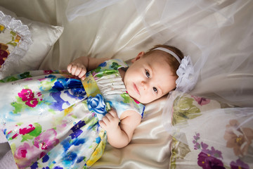 little girl laying on the bed