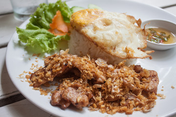 Fried pork with crispy garlic on rice + Fried egg