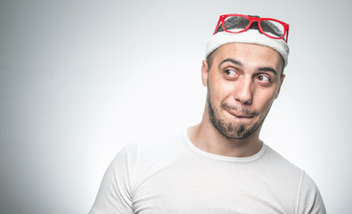 Portrait of funny sport man looking to side. Humorous comic face expression, isolated on gray background with copyspace