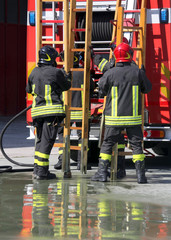 firefighters in action take the wooden ladder