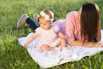 Fototapeta premium Happy mom and daughter playing at nature