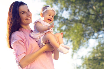 Happy mom and daughter playing at nature