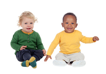 Couple of babies sitting on the floor