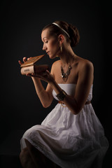 A girl acting Pandora as she opens the box