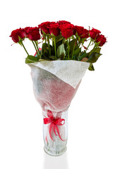 Bouquet of blossoming dark red roses in vase isolated on white b