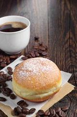 Sweet donut and coffee cup on table