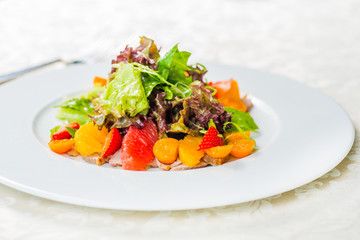 Fruit and vegetable salad on a white plate
