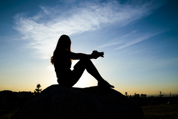 Female silhouette against the sky
