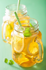 ice tea with lemon and melissa in mason jars