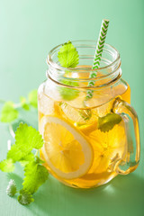 ice tea with lemon and melissa in mason jars