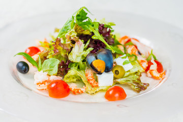 Seafood salad with vegetables on a white background